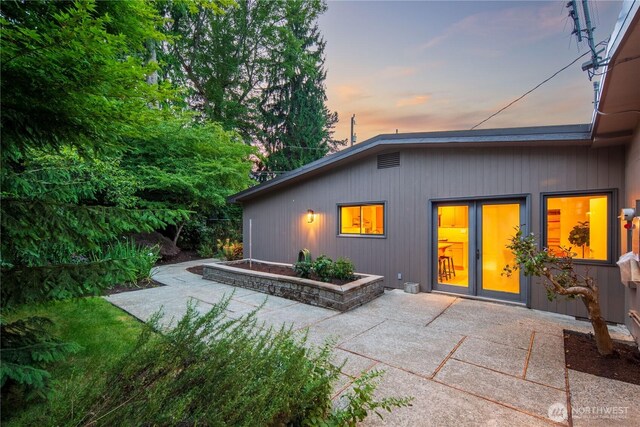 2325 38th Ave E, Seattle, WA 98112 - back of property at dusk featuring a patio area