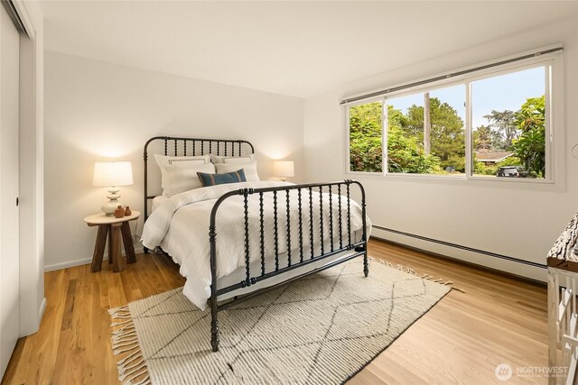 2325 38th Ave E, Seattle, WA 98112 - bedroom featuring a baseboard radiator and wood finished floors