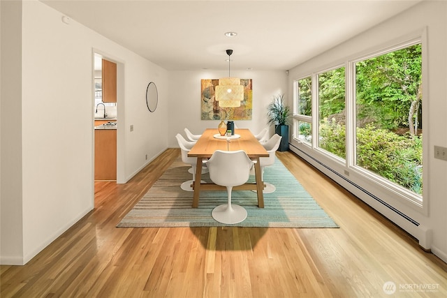 2325 38th Ave E, Seattle, WA 98112 - dining area with baseboard heating, light wood finished floors, and plenty of natural light