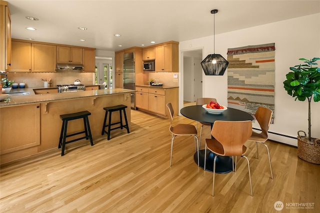 2325 38th Ave E, Seattle, WA 98112 - dining space with light wood-type flooring, recessed lighting, and a baseboard heating unit