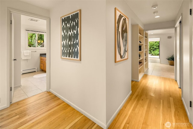 2325 38th Ave E, Seattle, WA 98112 - hall with baseboard heating, plenty of natural light, and light wood-style floors