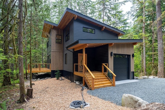 7489 Olsen Dr, Deming, WA 98244 - contemporary home with a garage, a wooden deck, and a view of trees