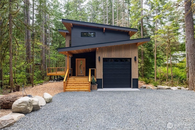 7489 Olsen Dr, Deming, WA 98244 - contemporary home featuring an attached garage, a view of trees, and gravel driveway