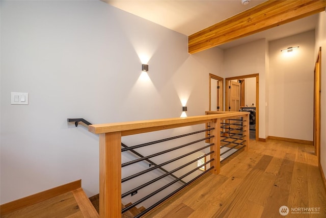 7489 Olsen Dr, Deming, WA 98244 - hallway with an upstairs landing, light wood-type flooring, and beam ceiling