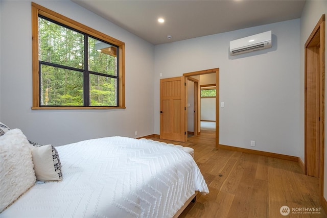 7489 Olsen Dr, Deming, WA 98244 - bedroom with a wall unit AC, light wood-style floors, and recessed lighting