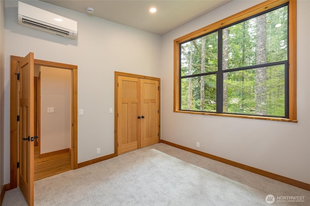 7489 Olsen Dr, Deming, WA 98244 - unfurnished bedroom featuring an AC wall unit and light colored carpet