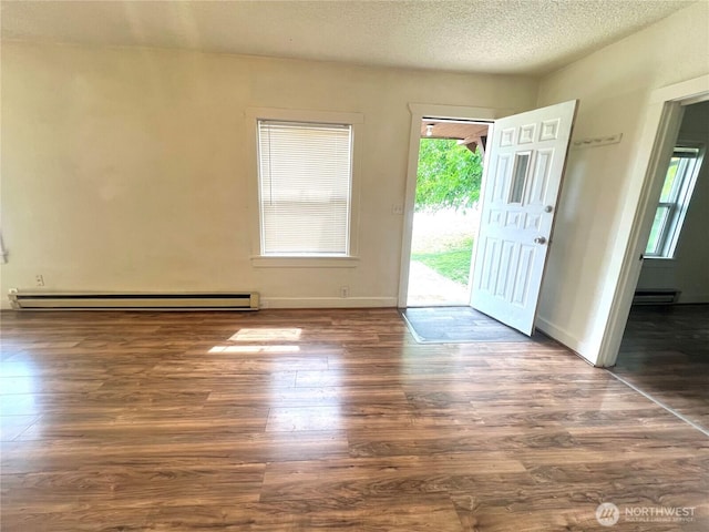 552 Maple St S, Okanogan, WA 98844 - entrance foyer with a baseboard radiator, wood finished floors, and a textured ceiling