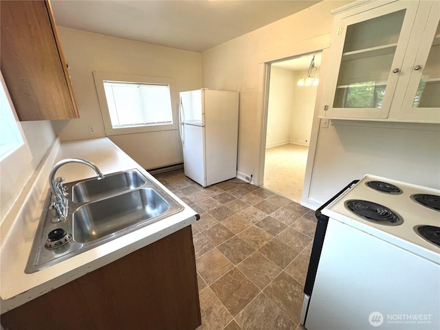 552 Maple St S, Okanogan, WA 98844 - kitchen featuring white appliances, light countertops, dark stone finish flooring, and glass insert cabinets
