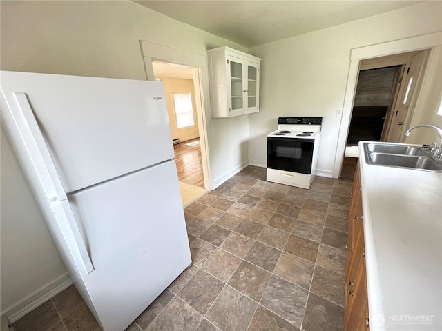 552 Maple St S, Okanogan, WA 98844 - kitchen featuring white appliances, white cabinets, glass insert cabinets, dark stone finish floors, and a baseboard heating unit