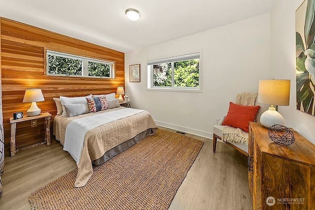 8608 12th Ave SW, Seattle, WA 98106 - bedroom featuring wood walls and light wood-style floors