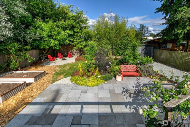 8608 12th Ave SW, Seattle, WA 98106 - fenced backyard featuring a vegetable garden and a patio