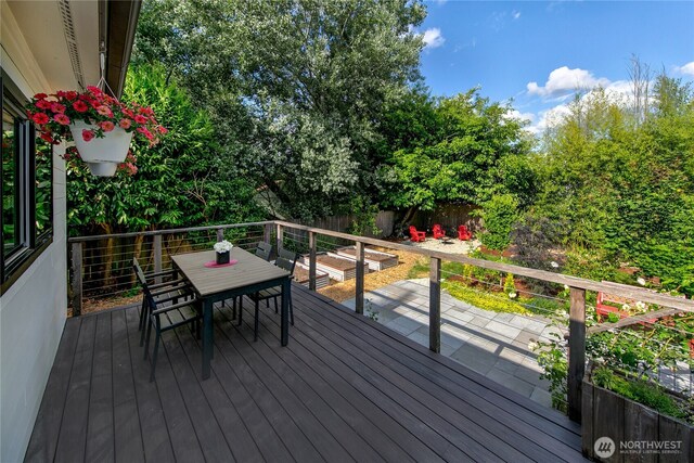 8608 12th Ave SW, Seattle, WA 98106 - wooden deck with outdoor dining space and a fenced backyard