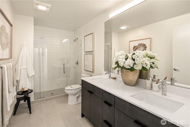 590 1st Ave S Unit 907, Seattle, WA 98104 - full bathroom featuring double vanity, a shower stall, and tile patterned floors