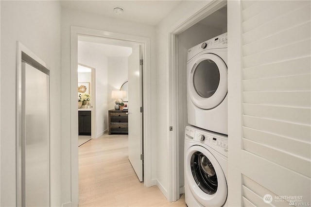 590 1st Ave S Unit 907, Seattle, WA 98104 - laundry area with stacked washing machine and dryer and light wood-style floors