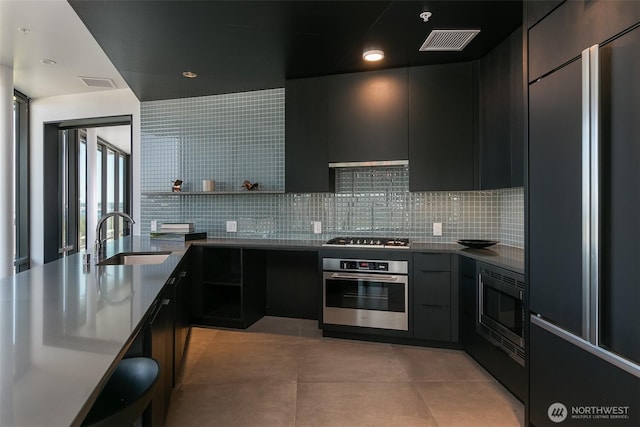 590 1st Ave S Unit 907, Seattle, WA 98104 - kitchen featuring built in appliances, modern cabinets, backsplash, open shelves, and dark cabinetry