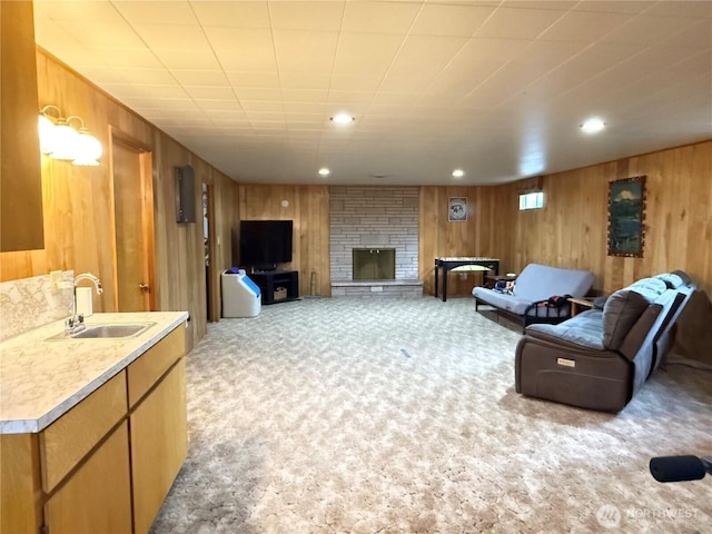 16 W Douglas St, Harrington, WA 99134 - living room featuring light carpet, wooden walls, a stone fireplace, and recessed lighting