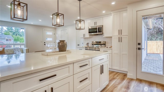 840 SW 306th St, Federal Way, WA 98023 - kitchen featuring appliances with stainless steel finishes, tasteful backsplash, white cabinets, light wood-style floors, and recessed lighting