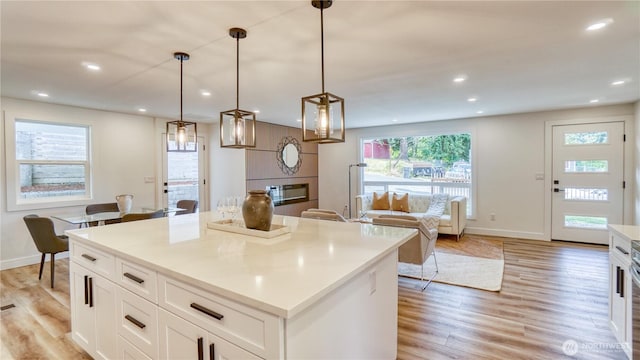 840 SW 306th St, Federal Way, WA 98023 - kitchen with recessed lighting, light wood-type flooring, a kitchen island, white cabinetry, and pendant lighting