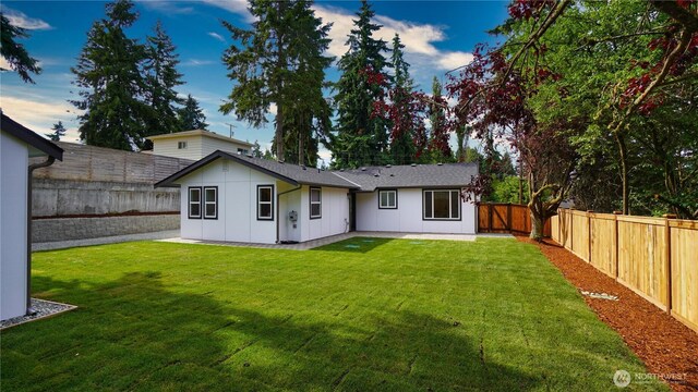 840 SW 306th St, Federal Way, WA 98023 - rear view of property with a fenced backyard, board and batten siding, and a patio