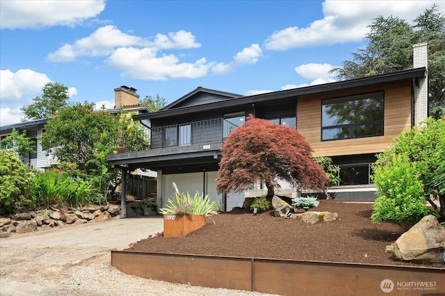 6024 Gould Ave S, Seattle, WA 98108 - view of front of property featuring driveway, a garage, a chimney, and a balcony