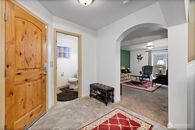 7230 178th St E, Puyallup, WA 98375 - foyer entrance featuring arched walkways and light carpet