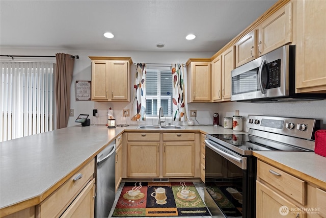 7230 178th St E, Puyallup, WA 98375 - kitchen with stainless steel appliances, light brown cabinetry, a peninsula, light countertops, and recessed lighting