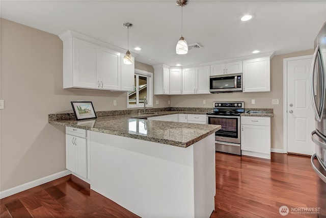 3005 Old Morse Rd SE, Olympia, WA 98501 - kitchen with appliances with stainless steel finishes, a peninsula, white cabinets, and recessed lighting