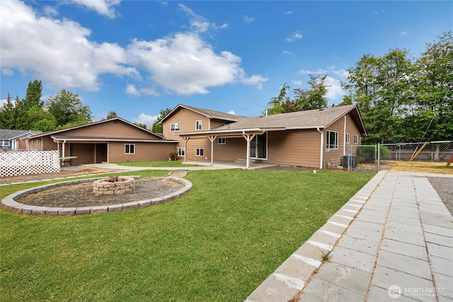3005 Old Morse Rd SE, Olympia, WA 98501 - back of property with a fire pit, an attached garage, a patio area, and roof with shingles
