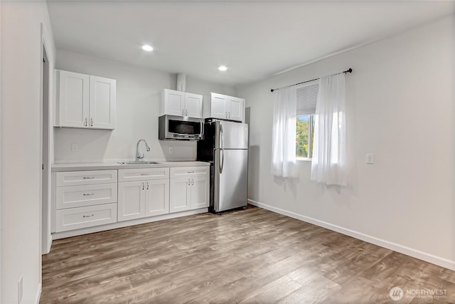 3005 Old Morse Rd SE, Olympia, WA 98501 - kitchen with appliances with stainless steel finishes, light wood-style floors, white cabinets, light countertops, and recessed lighting