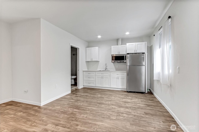 3005 Old Morse Rd SE, Olympia, WA 98501 - kitchen featuring appliances with stainless steel finishes, light wood-style floors, white cabinets, recessed lighting, and light countertops