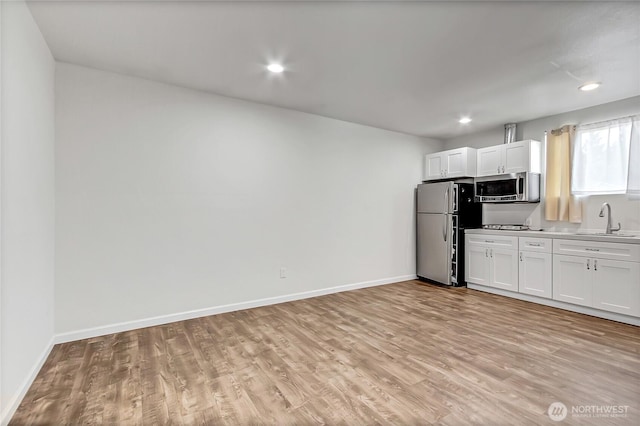 3005 Old Morse Rd SE, Olympia, WA 98501 - kitchen featuring appliances with stainless steel finishes, light wood-style flooring, white cabinetry, and recessed lighting