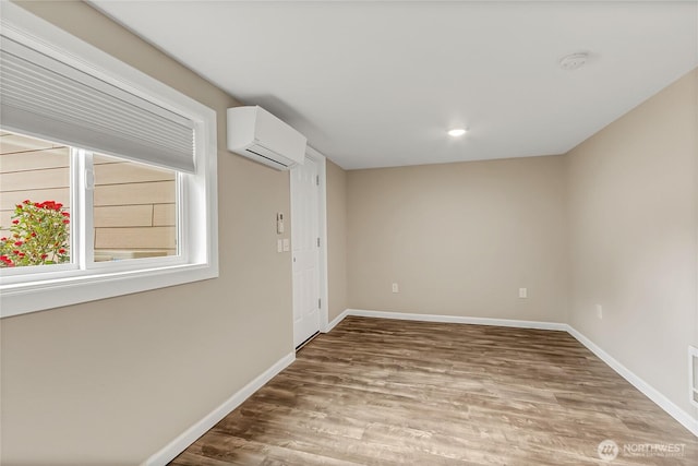 3005 Old Morse Rd SE, Olympia, WA 98501 - unfurnished room featuring a wall unit AC, wood finished floors, and a smoke detector