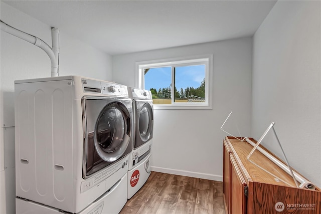 3005 Old Morse Rd SE, Olympia, WA 98501 - laundry room featuring independent washer and dryer, wood finished floors, and cabinet space