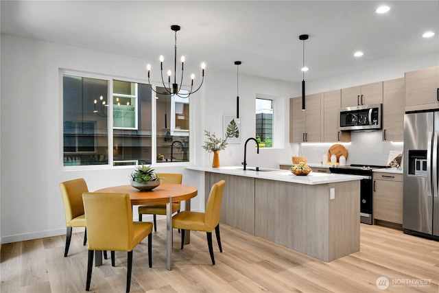629A W Emerson Ave, Seattle, WA 98119 - kitchen featuring appliances with stainless steel finishes, modern cabinets, light countertops, light wood-style flooring, and recessed lighting