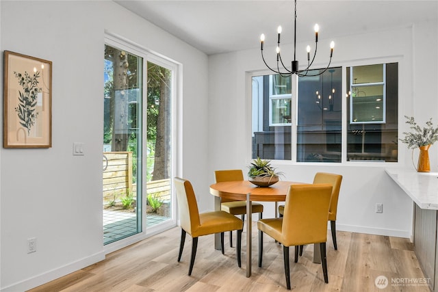 629A W Emerson Ave, Seattle, WA 98119 - dining space with light wood-type flooring and a chandelier