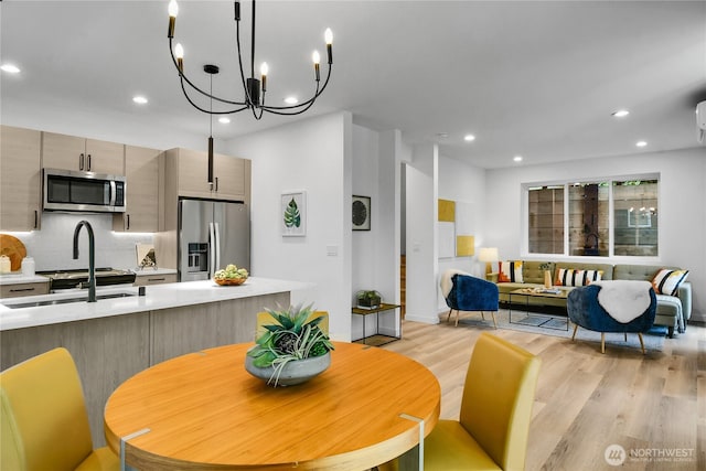 629A W Emerson Ave, Seattle, WA 98119 - dining room featuring light wood-style flooring, recessed lighting, and a chandelier