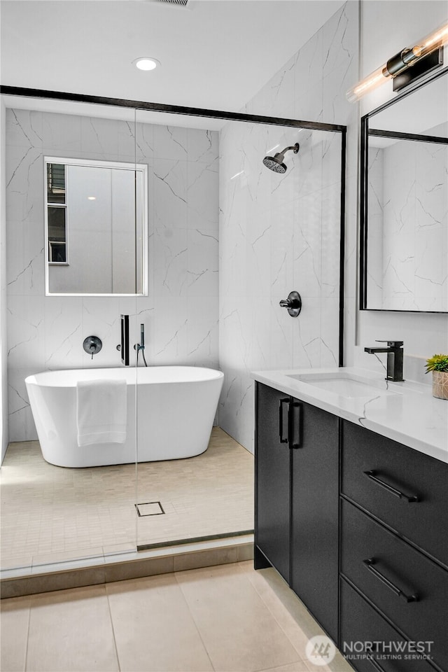 629A W Emerson Ave, Seattle, WA 98119 - bathroom featuring vanity, a soaking tub, tile walls, recessed lighting, and tile patterned floors