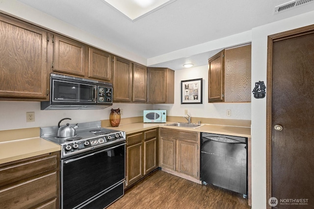 11300 1st Ave NE Unit 224, Seattle, WA 98125 - kitchen featuring black appliances, dark wood-style flooring, and light countertops
