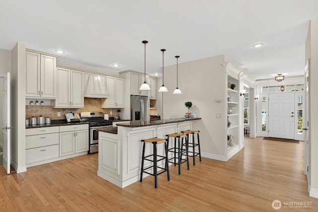 2414 42nd Pl, Anacortes, WA 98221 - kitchen with stainless steel appliances, a kitchen breakfast bar, light wood-style flooring, a peninsula, and recessed lighting