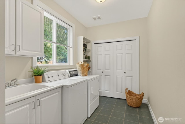 2414 42nd Pl, Anacortes, WA 98221 - laundry room with cabinet space, washer and clothes dryer, and dark tile patterned flooring