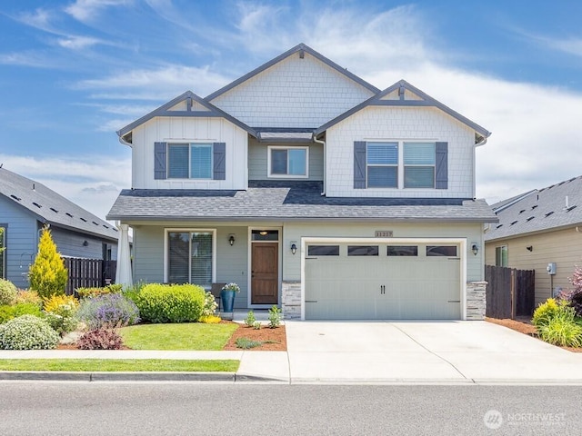 11217 NE 134th Pl, Vancouver, WA 98682 - craftsman-style house featuring concrete driveway, an attached garage, stone siding, board and batten siding, and a porch