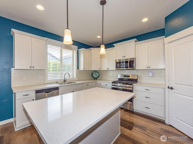 11217 NE 134th Pl, Vancouver, WA 98682 - kitchen with appliances with stainless steel finishes, white cabinets, dark wood-style floors, backsplash, and recessed lighting