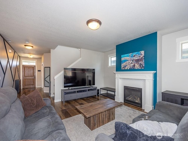 11217 NE 134th Pl, Vancouver, WA 98682 - living room featuring wood finished floors, a tiled fireplace, and stairway