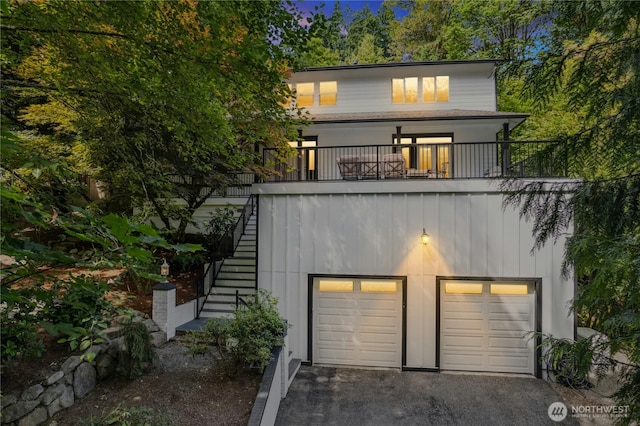 17519 33rd Ave NE, Lake Forest Park, WA 98155 - view of front of home with stairs, a garage, a balcony, and asphalt driveway