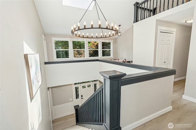 17519 33rd Ave NE, Lake Forest Park, WA 98155 - stairway with a chandelier, wood finished floors, and a high ceiling