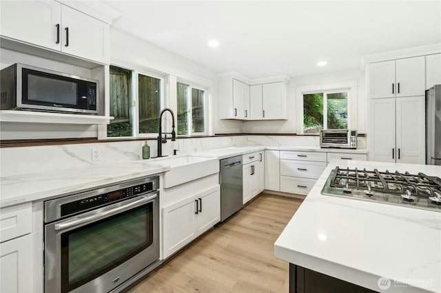 17519 33rd Ave NE, Lake Forest Park, WA 98155 - kitchen with appliances with stainless steel finishes, white cabinetry, light stone countertops, and recessed lighting