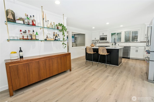 17519 33rd Ave NE, Lake Forest Park, WA 98155 - kitchen featuring appliances with stainless steel finishes, white cabinetry, light wood finished floors, light countertops, and recessed lighting