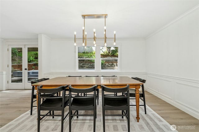 17519 33rd Ave NE, Lake Forest Park, WA 98155 - dining area featuring plenty of natural light, light wood-style flooring, ornamental molding, and a wainscoted wall