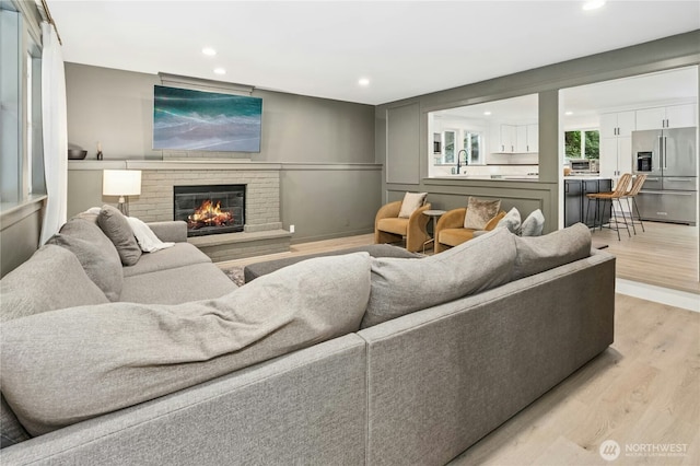 17519 33rd Ave NE, Lake Forest Park, WA 98155 - living area with light wood-type flooring, recessed lighting, and a brick fireplace
