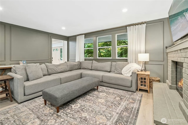 17519 33rd Ave NE, Lake Forest Park, WA 98155 - living room with a decorative wall, wood finished floors, a fireplace, and recessed lighting